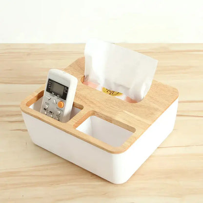 a cell phone and a tissue dispenser on a wooden table