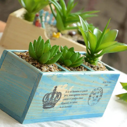 a wooden box with plants in it sitting on a table