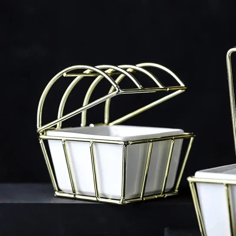 a set of three white and gold dishes