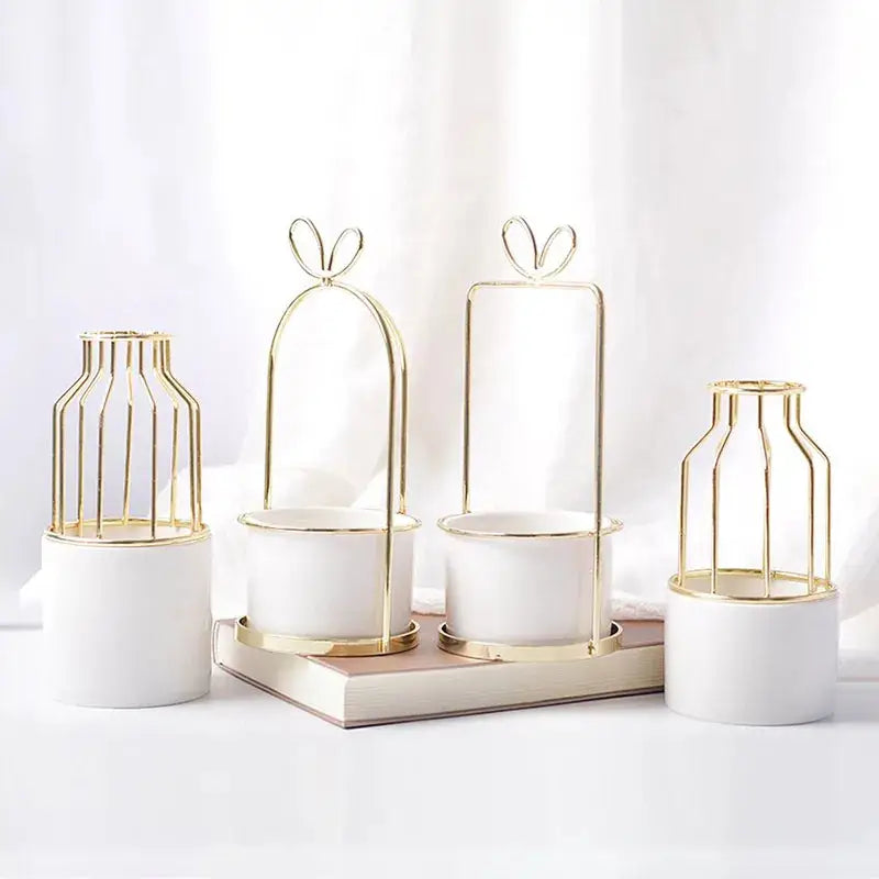 a group of three white vases sitting on top of a table