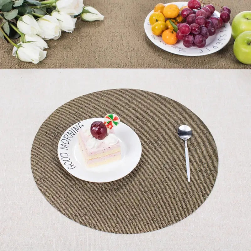 a table topped with a plate of cake next to a bowl of fruit