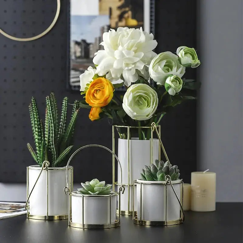 a table topped with three white vases filled with flowers