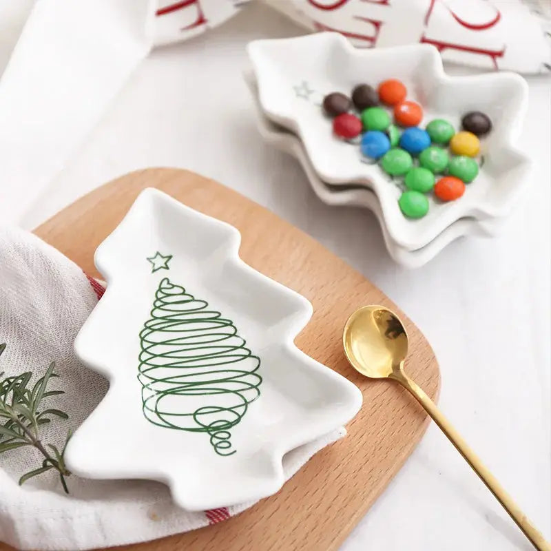 a white plate with a green christmas tree on it