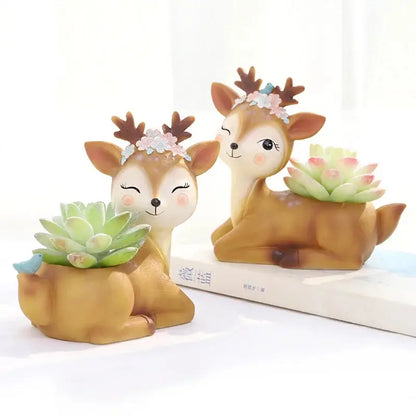 a couple of deer figurines sitting on top of a book