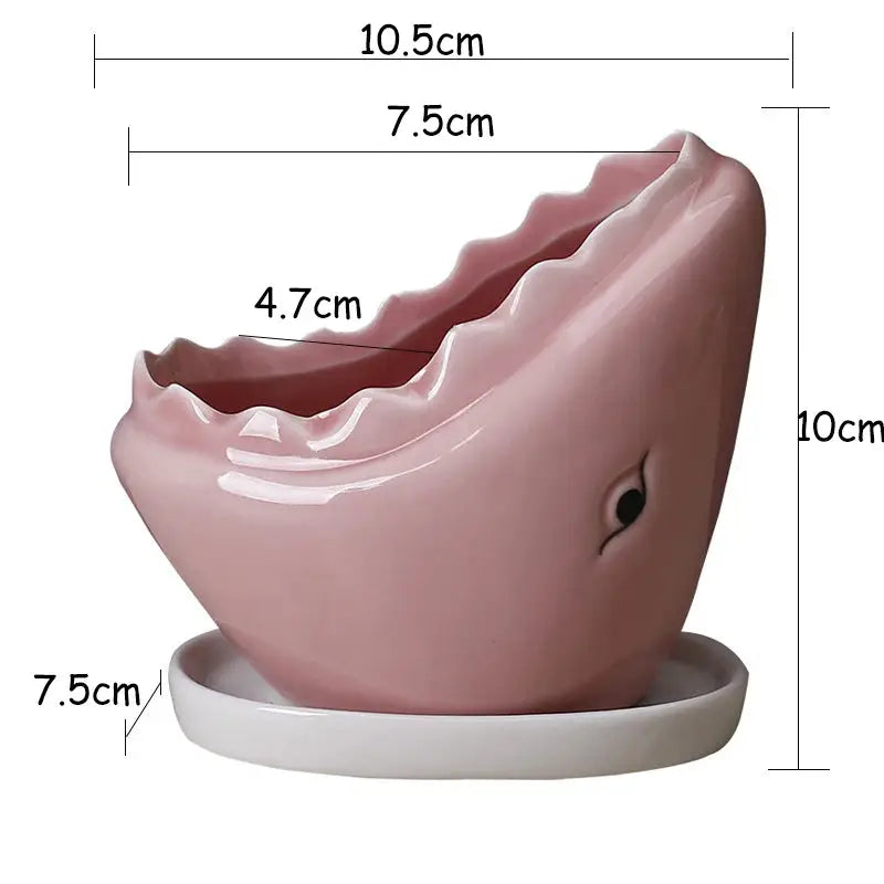 a pink toothbrush holder on a white base