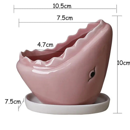 a pink toothbrush holder on a white base