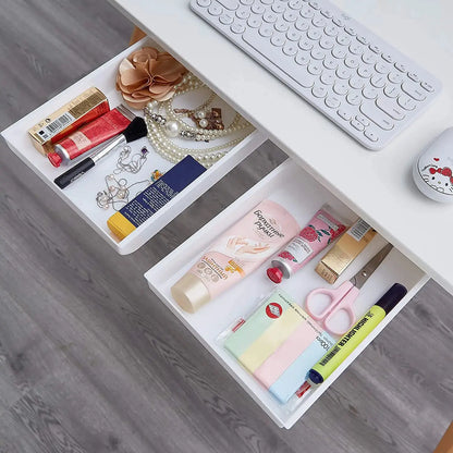 a desk with a keyboard, mouse, and various cosmetics