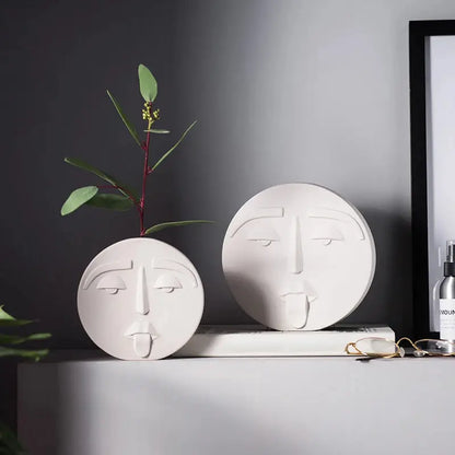 a couple of white vases sitting on top of a table