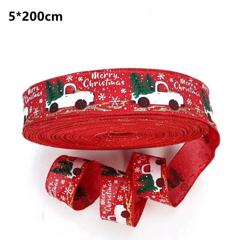 a roll of red christmas ribbon with a truck on it