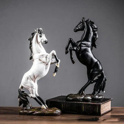 a couple of statues of horses on top of a table