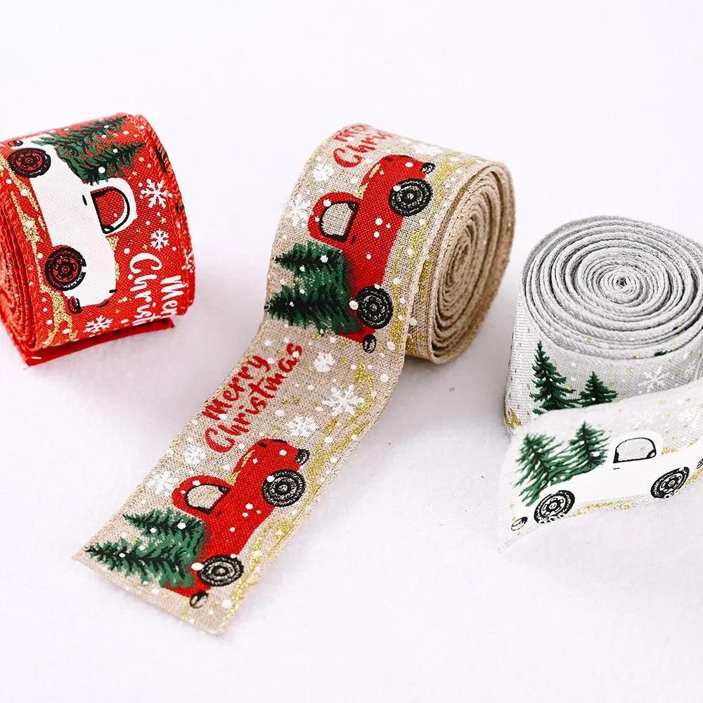a couple of rolls of christmas ribbon next to each other