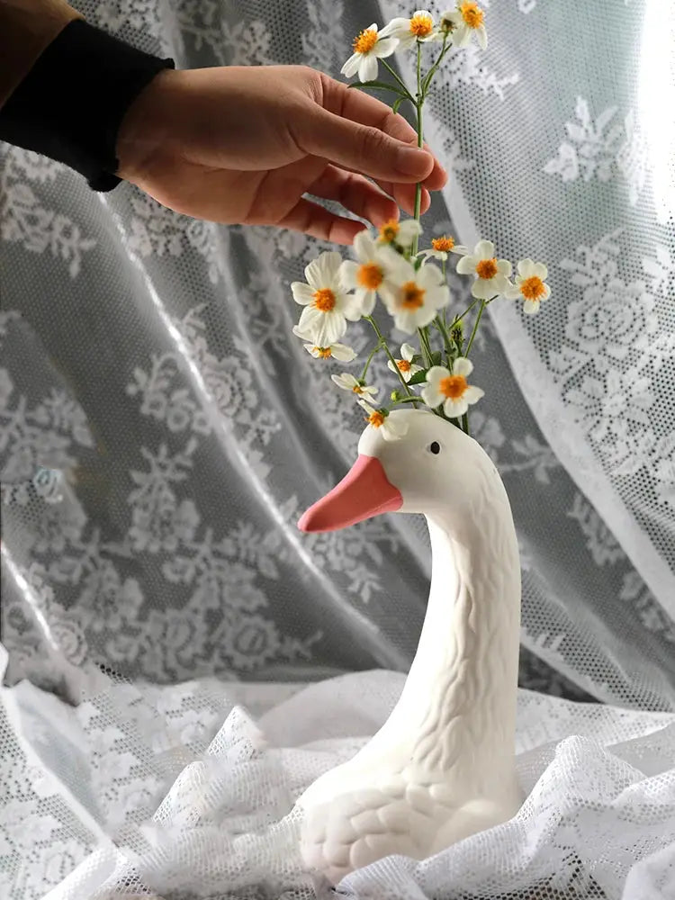 a person holding a vase with flowers in it