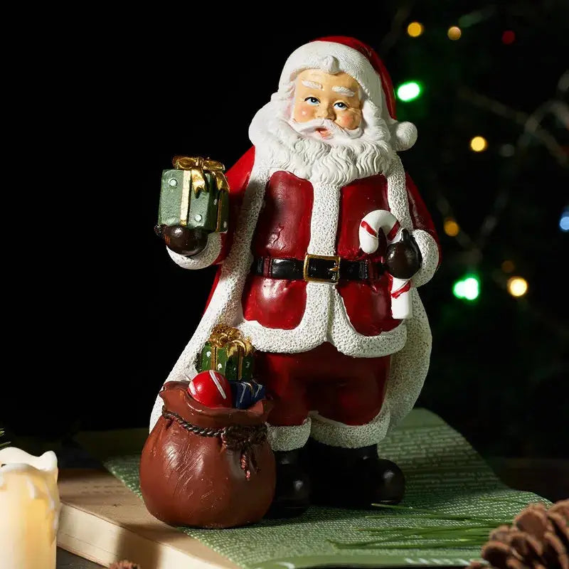 a santa clause figurine holding a gift bag