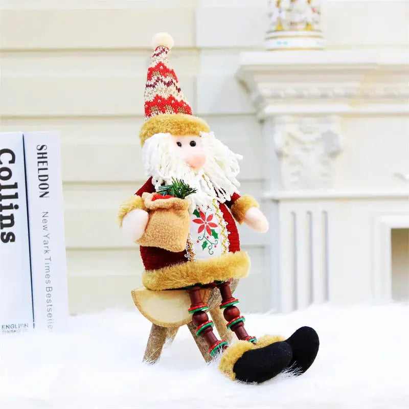 a small christmas decoration sitting on top of a snow covered ground