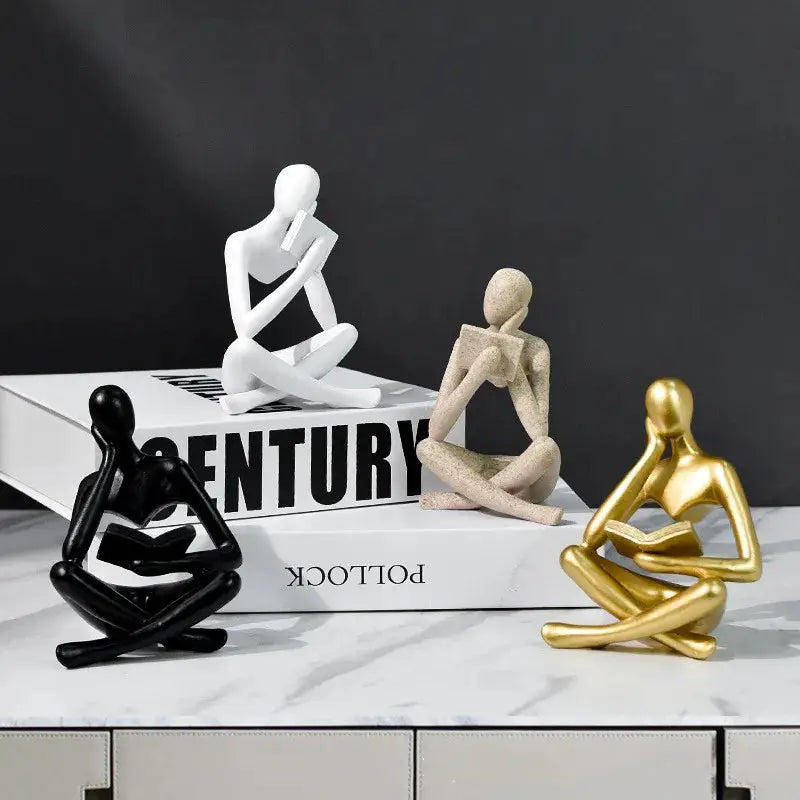 a couple of figurines sitting on top of a table