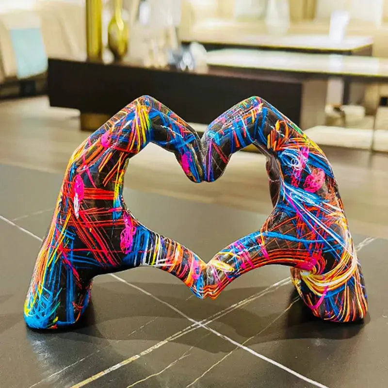 a colorful sculpture of a person making a heart