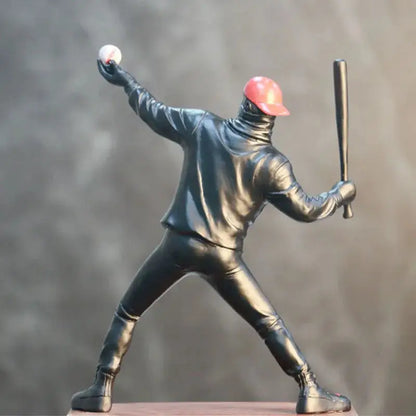 a statue of a baseball player holding a bat