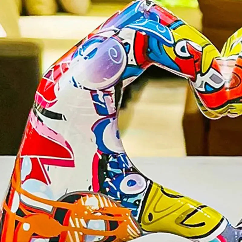 a colorful sculpture of a woman sitting on a table