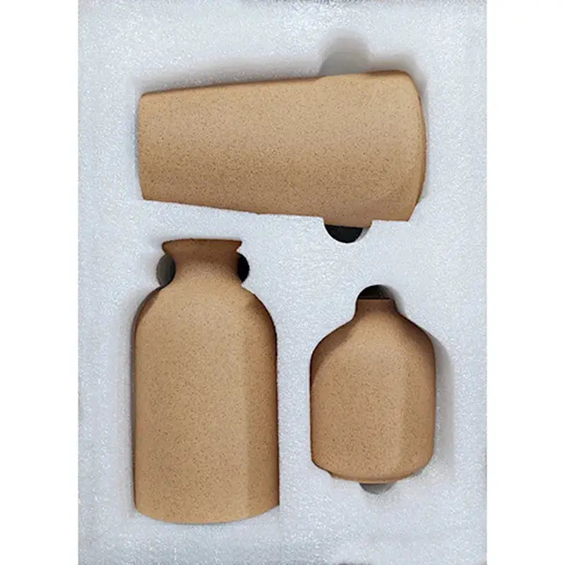 a set of three brown vases in a box