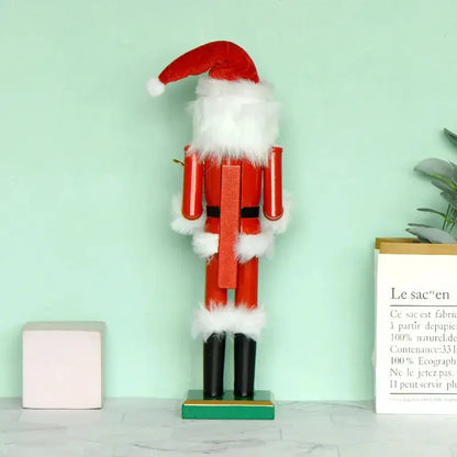 a wooden nutcracker with a santa hat on