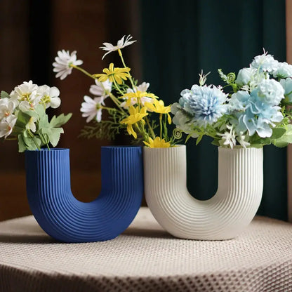 three vases with flowers in them sitting on a table