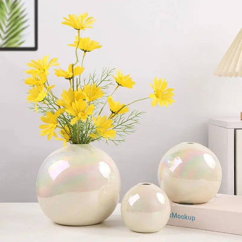 a vase filled with yellow flowers on top of a table