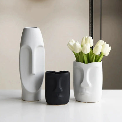 three vases with flowers in them sitting on a table