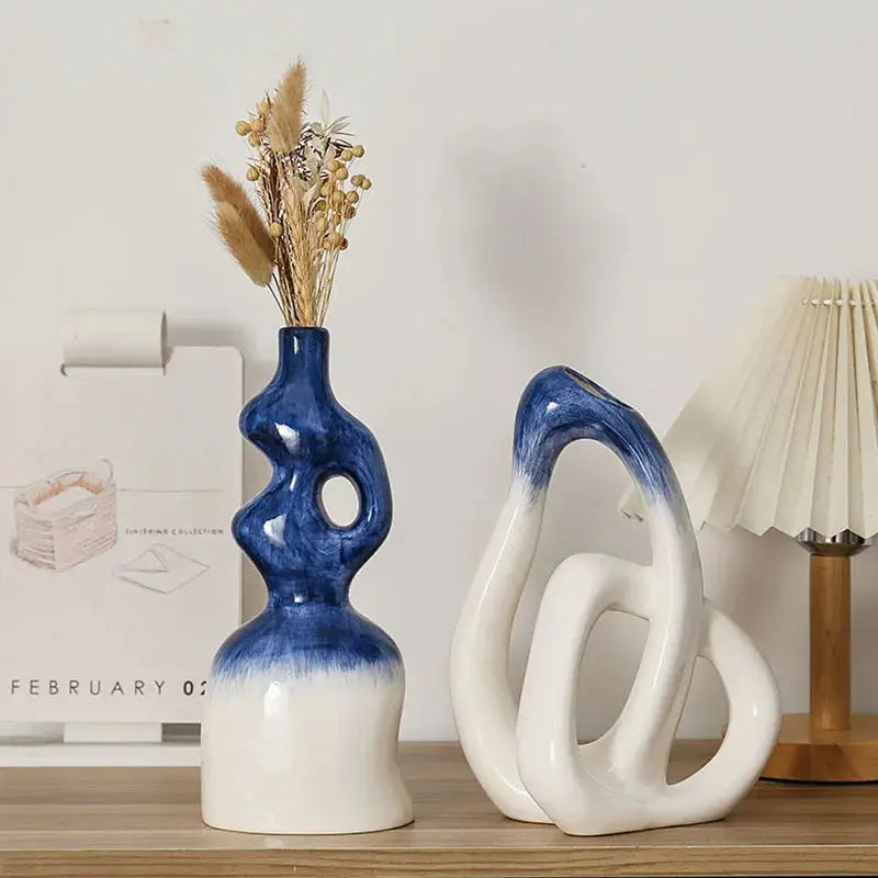 a blue and white vase sitting on top of a wooden table