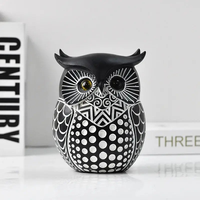 a black and white owl figurine sitting on a table