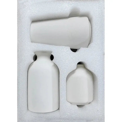 a set of three white vases in a box