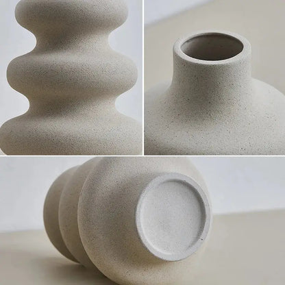 a white vase sitting on top of a table