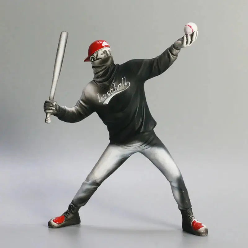 a statue of a baseball player holding a bat