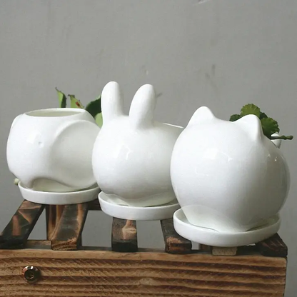 a group of white ceramic animals sitting on top of each other