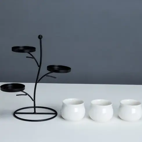 a white table topped with three white cups