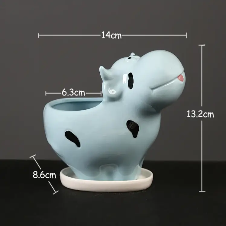 a blue ceramic animal planter with a hole in it