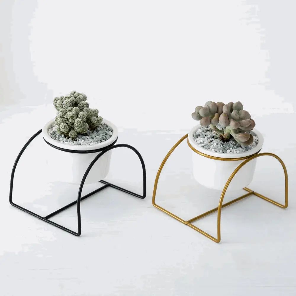 a couple of planters sitting on top of a metal stand
