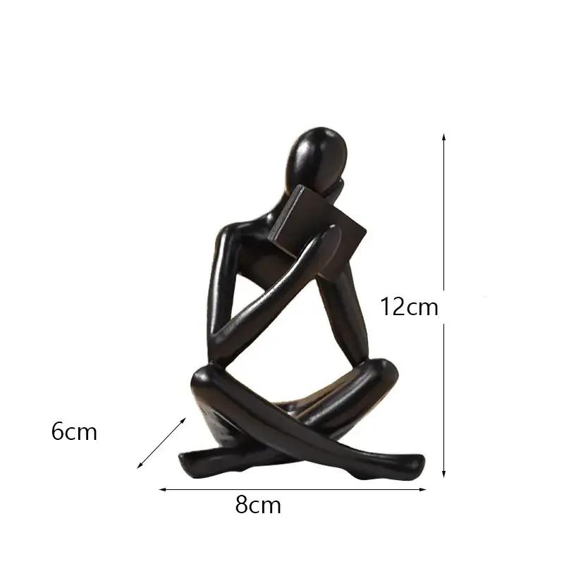 a black statue of a person sitting on a white background