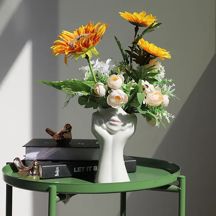 a vase of flowers on a table with books